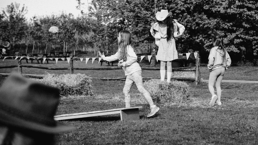Black and white photo of three girls playing games in the field at Bluegrass Omagh