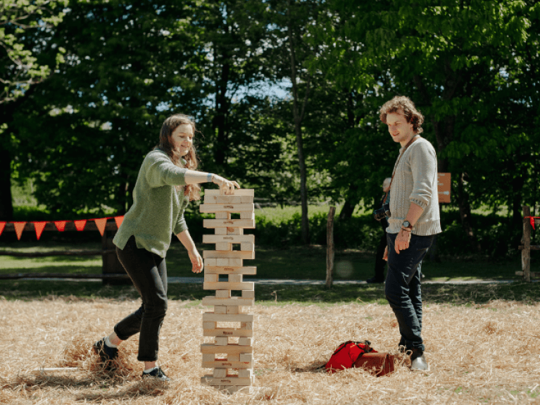 a man and a woman playing giant jenga