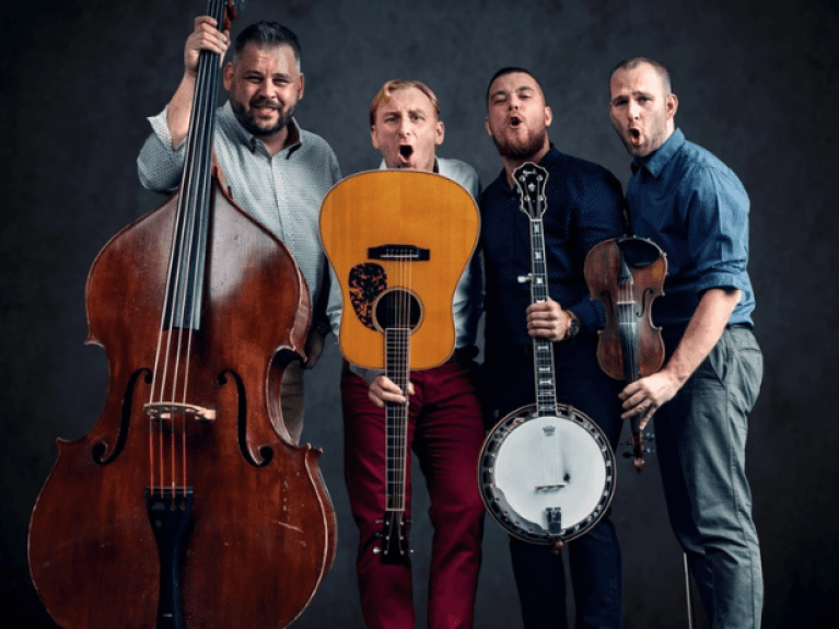 the bluegrass band milkeater (4 men) holding instruments