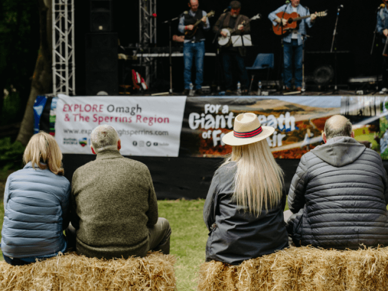 two couples watching music at bluegrass omagh 2022